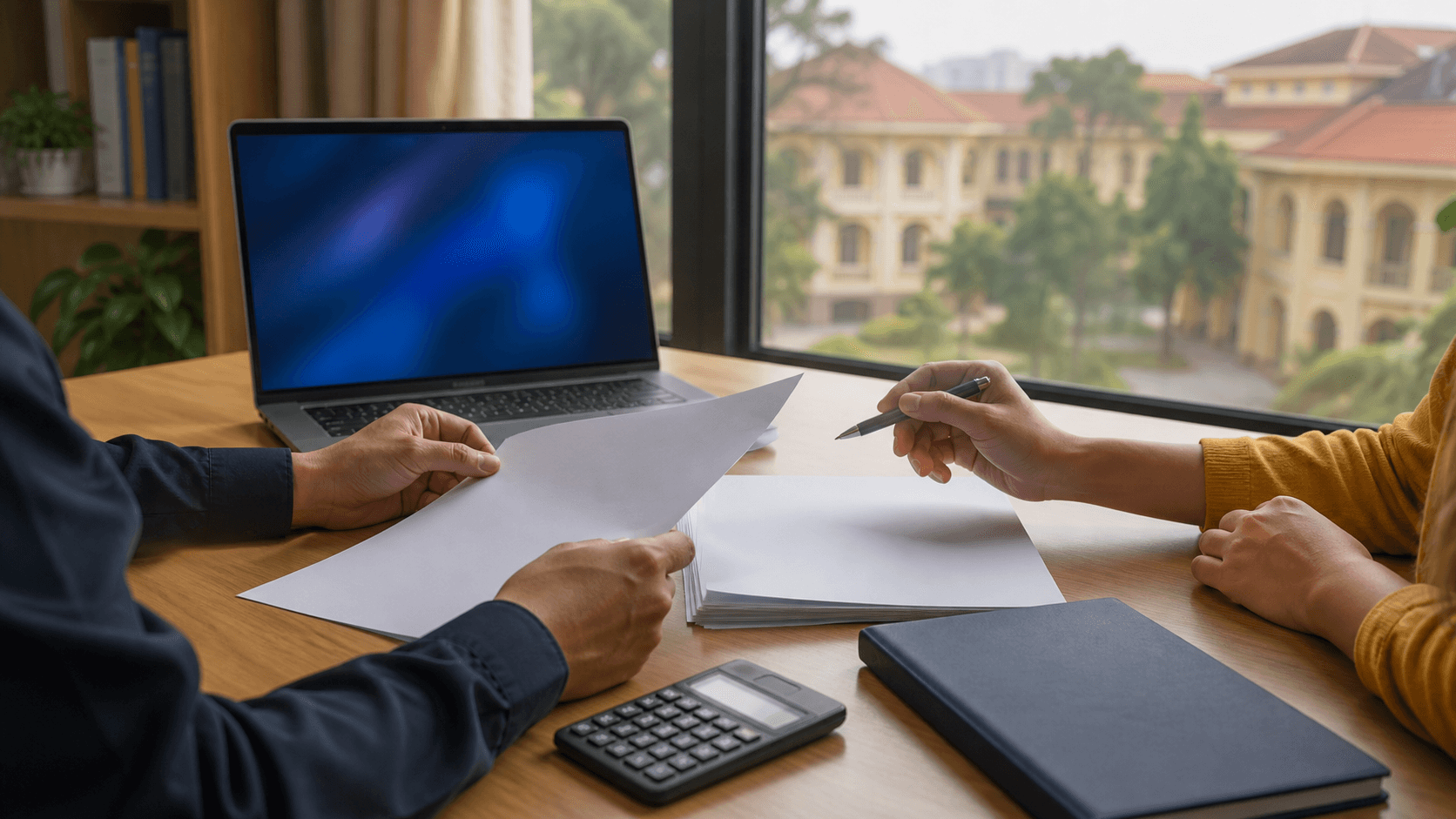 Indian parent and student reviewing blank fee papers beside a laptop and calculator at a study desk with a Vietnam campus backdrop